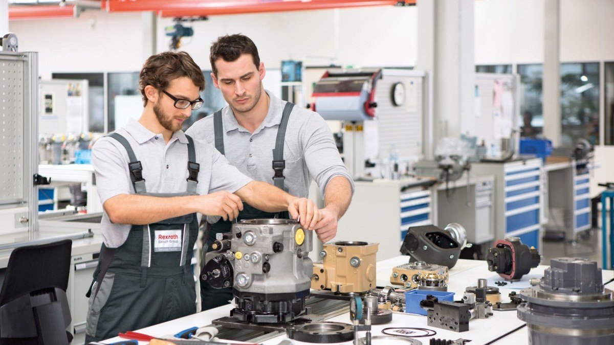 Engineers working on hydraulic components